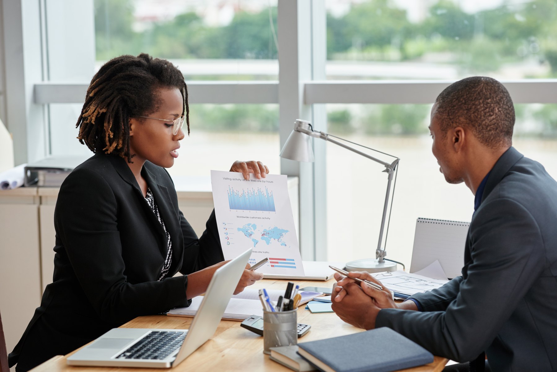 A leader showing performance charts to a colleague during a people decision conversation